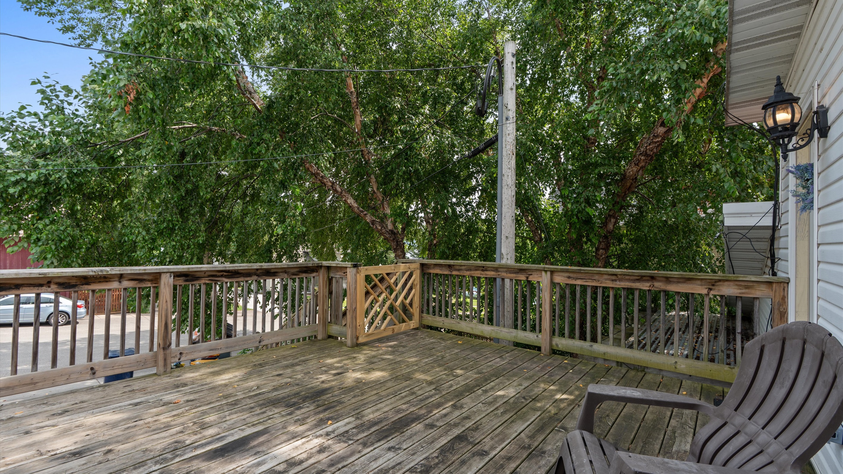 Catch the sunset from the attached deck through the neighboring trees.