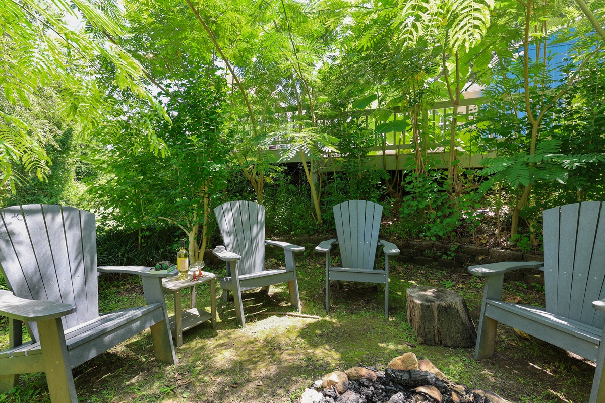 Fire pit area behind the house with river views