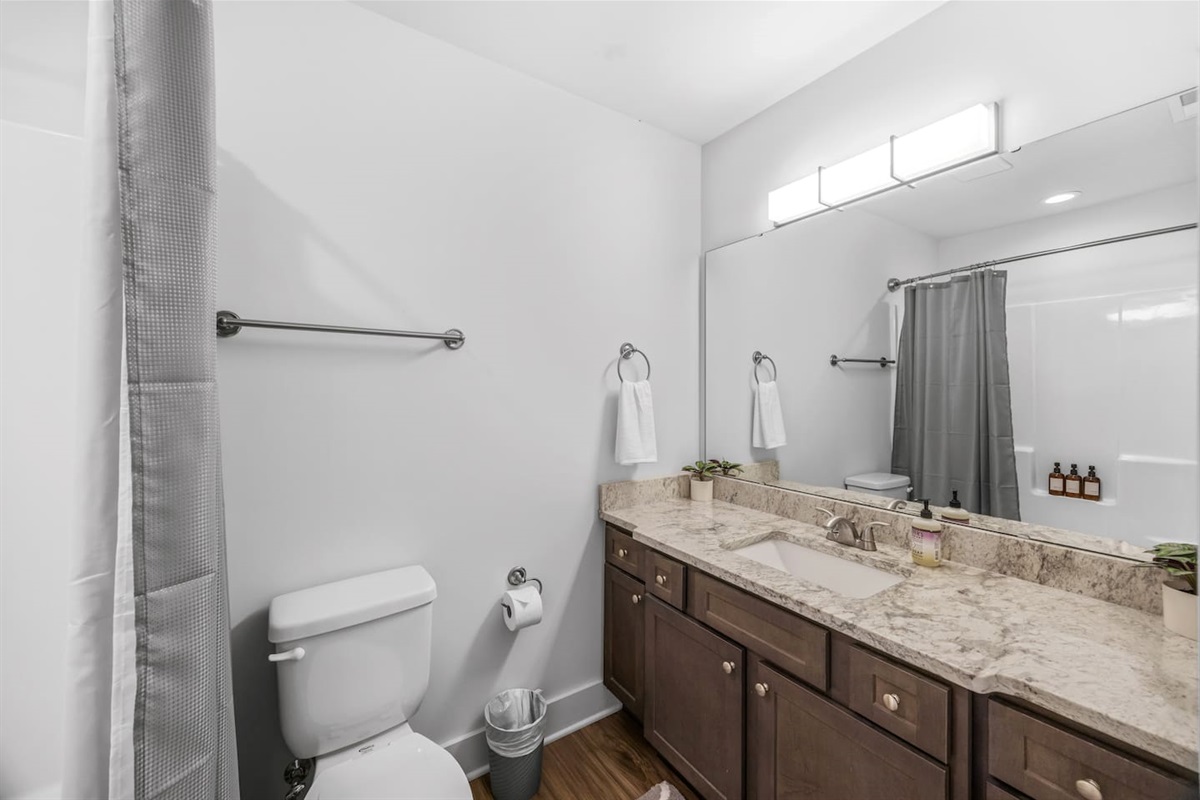 Features a granite vanity, shower/tub combo, and fresh modern design for added comfort and convenience.