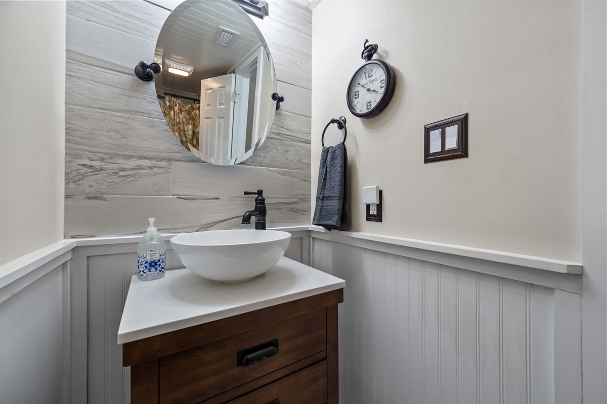 Bathroom vanity with round mirror and vessel sink