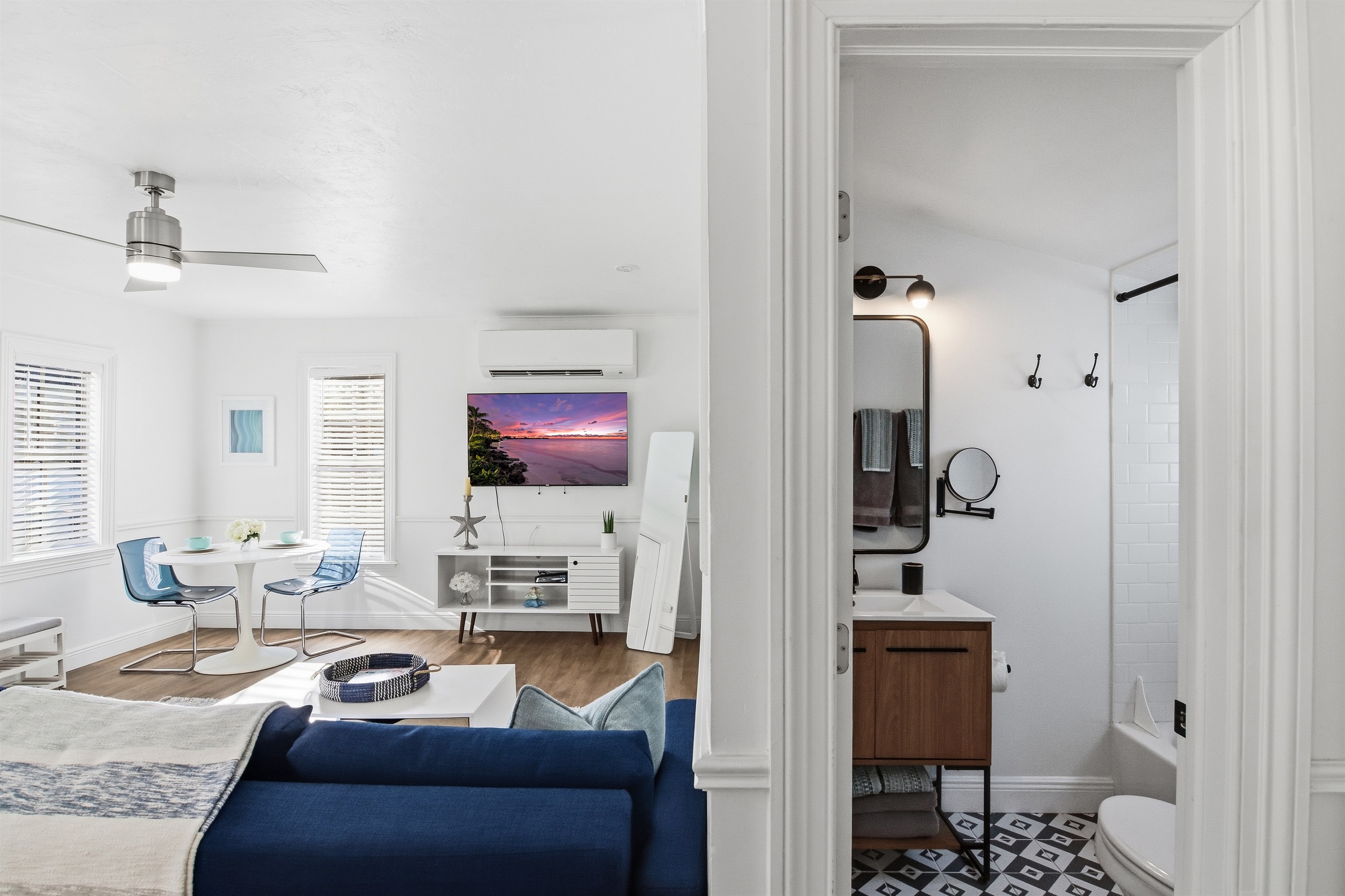 Full bathroom, king bed, living area, dining/workspace and kitchen