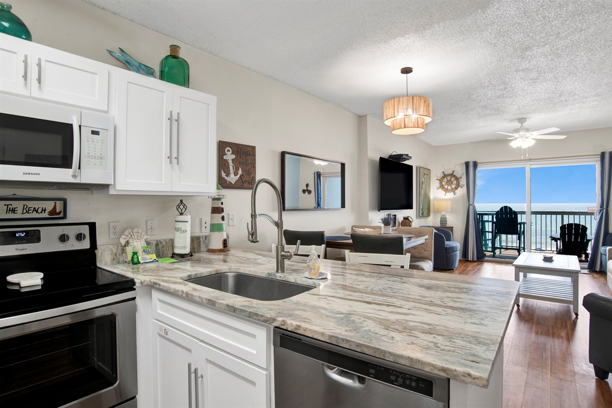Kitchen with stainless steel appliances, granite tops and beautiful gulf view.