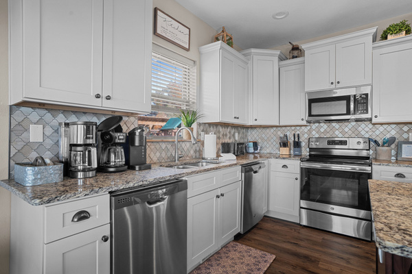 Main level kitchen. Two full-size refrigerators, two dishwashers, oven/ceramic glass cooktop, microwave, drip coffee maker, Keurig, and Nespresso. Stocked with small appliances, cookware, bakeware, utensils, dishes, glassware, mugs, and more!