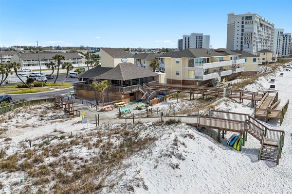 Your beach day just got easier! 🏖️ Once you finish your walk down the private boardwalk, look for the red umbrellas. Your stay includes professional beach service.