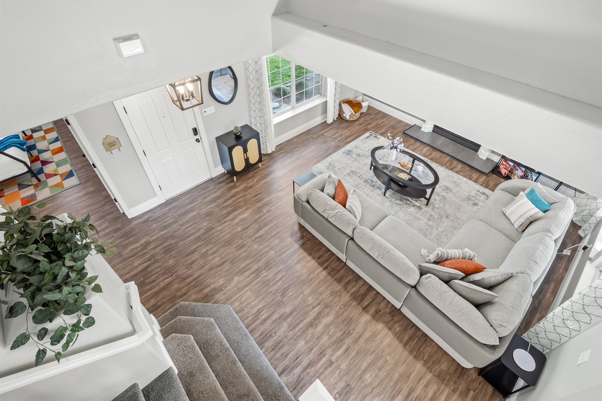 Open-concept living area with soaring ceilings, oversized sectional seating, and plenty of space for everyone to gather, play, and relax together.