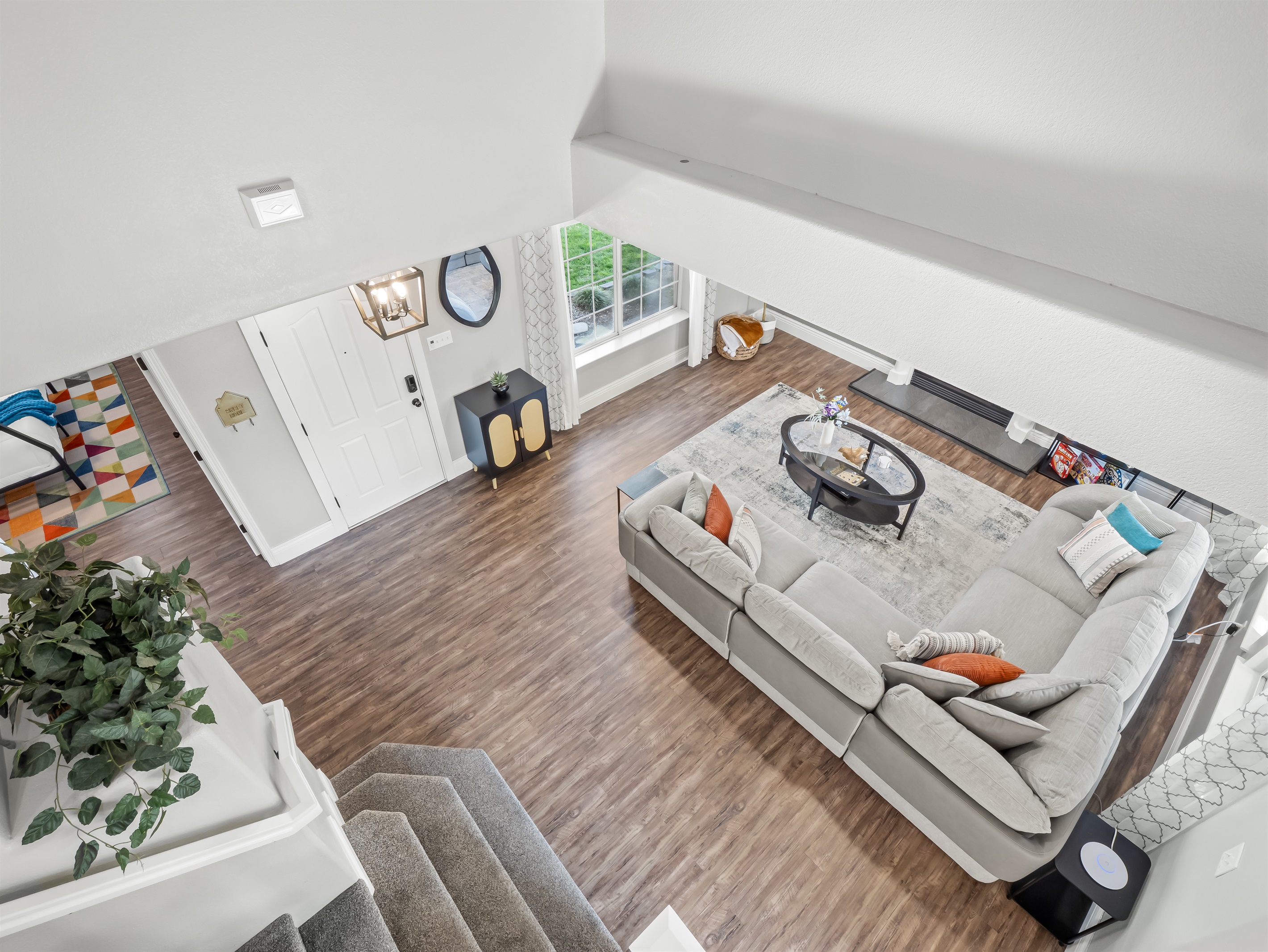 Open-concept living area with soaring ceilings, oversized sectional seating, and plenty of space for everyone to gather, play, and relax together.