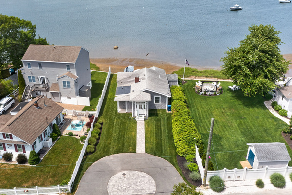Aerial view showcasing the home's beautiful waterfront setting and scenic surroundings.