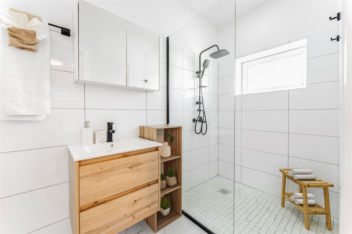 Refresh in the modern ensuite featuring a spacious glass walk-in rainfall shower