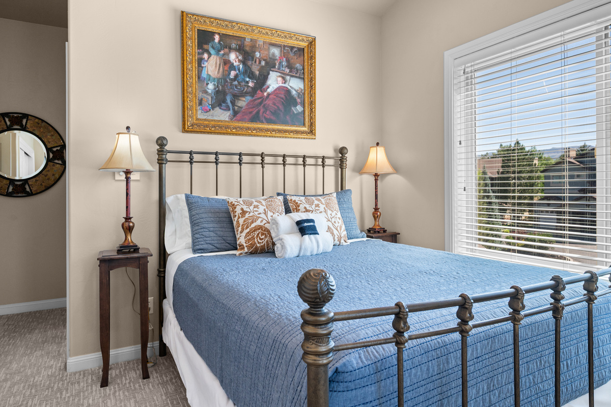 Comfortable bedroom with charming décor, additional sleeping space, and lovely views.