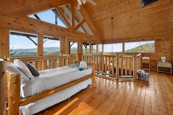 The upper suite's trundle bed sleeps two — perfect for kids who want to be near the adults. The deck door opens directly to the upper rocking chair porch.