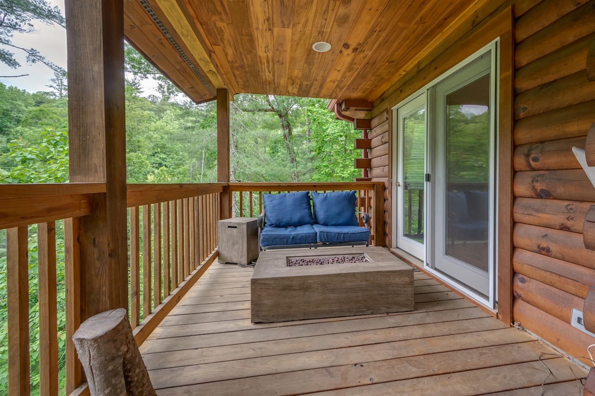 Lower level deck overlooking river with firepit