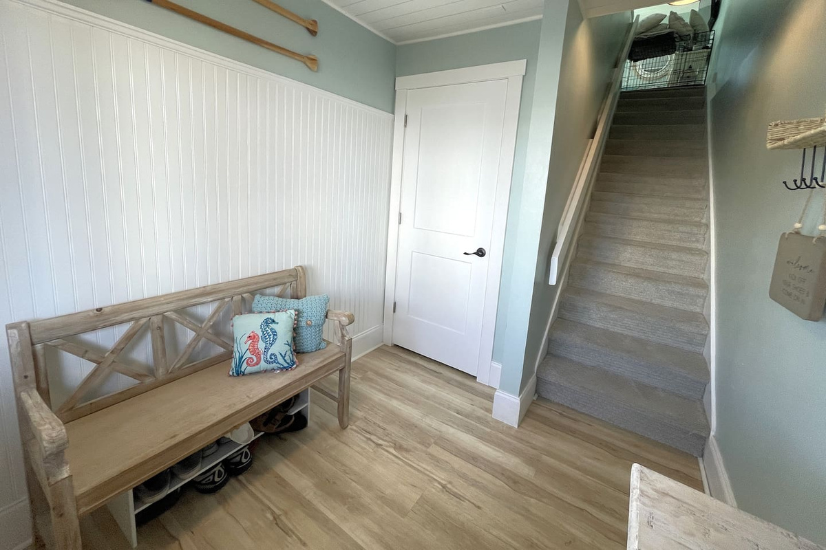 Foyer Entrance with Carpeted Stairs up to Main Level