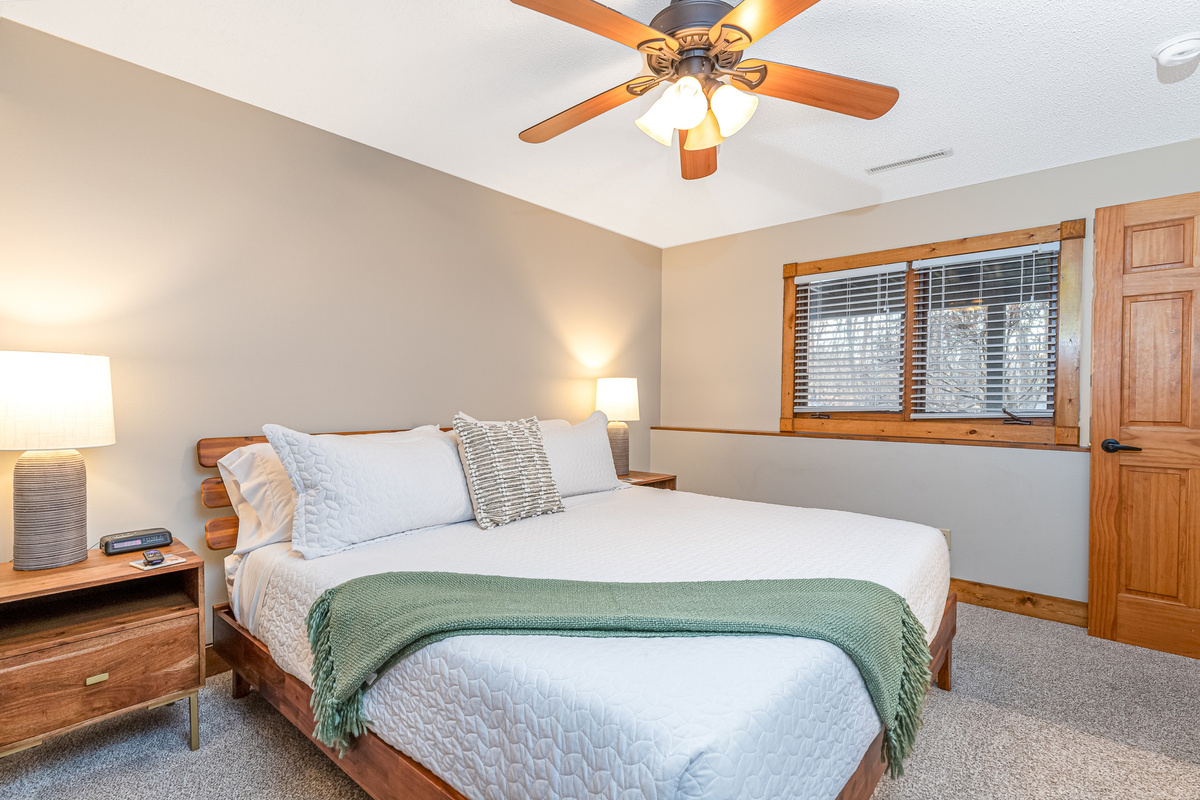 Bedroom 5 featuring a King bed and a Roku Smart TV, and an ensuite bathroom; one of three bedrooms located on the lower level.