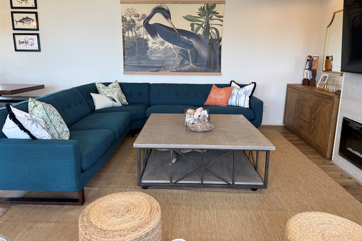 Several seats several to enjoy the 70" TV, electric fireplace, and bar at the side table. 