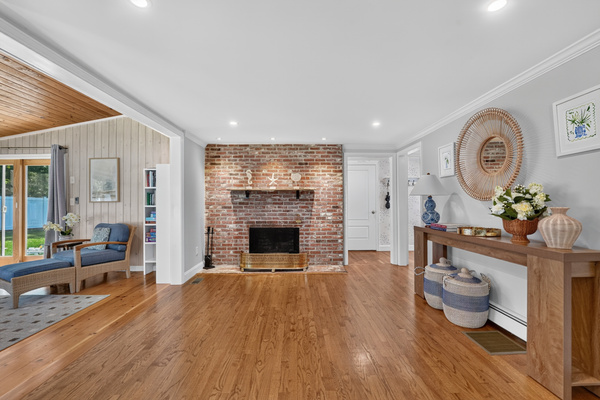 Warm and inviting living room featuring a classic brick fireplace.