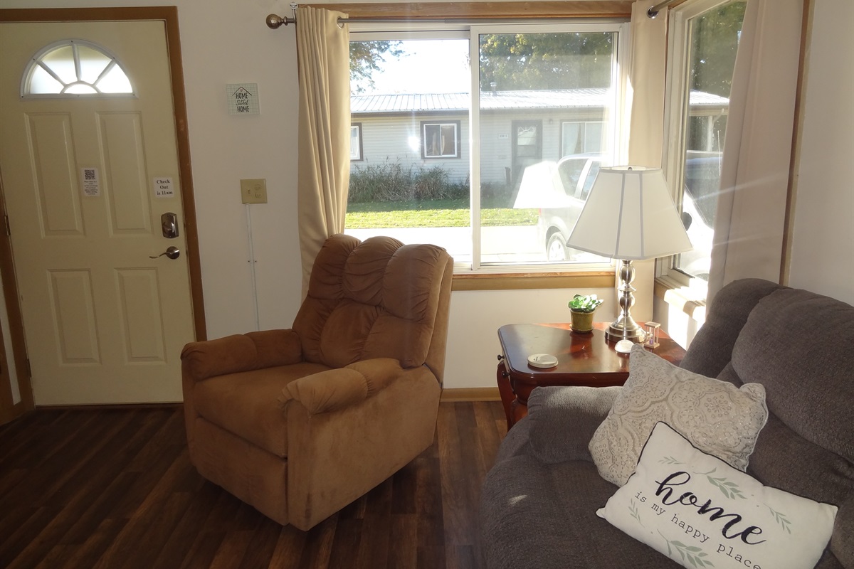 Living room with 2 recliners, reclining couch and Roku smart TV