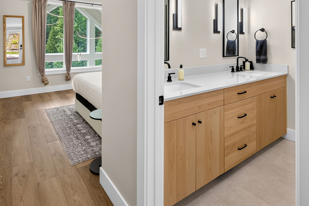 This bathroom is private to the primary bedroom and includes dual vanity, shower and toilet.