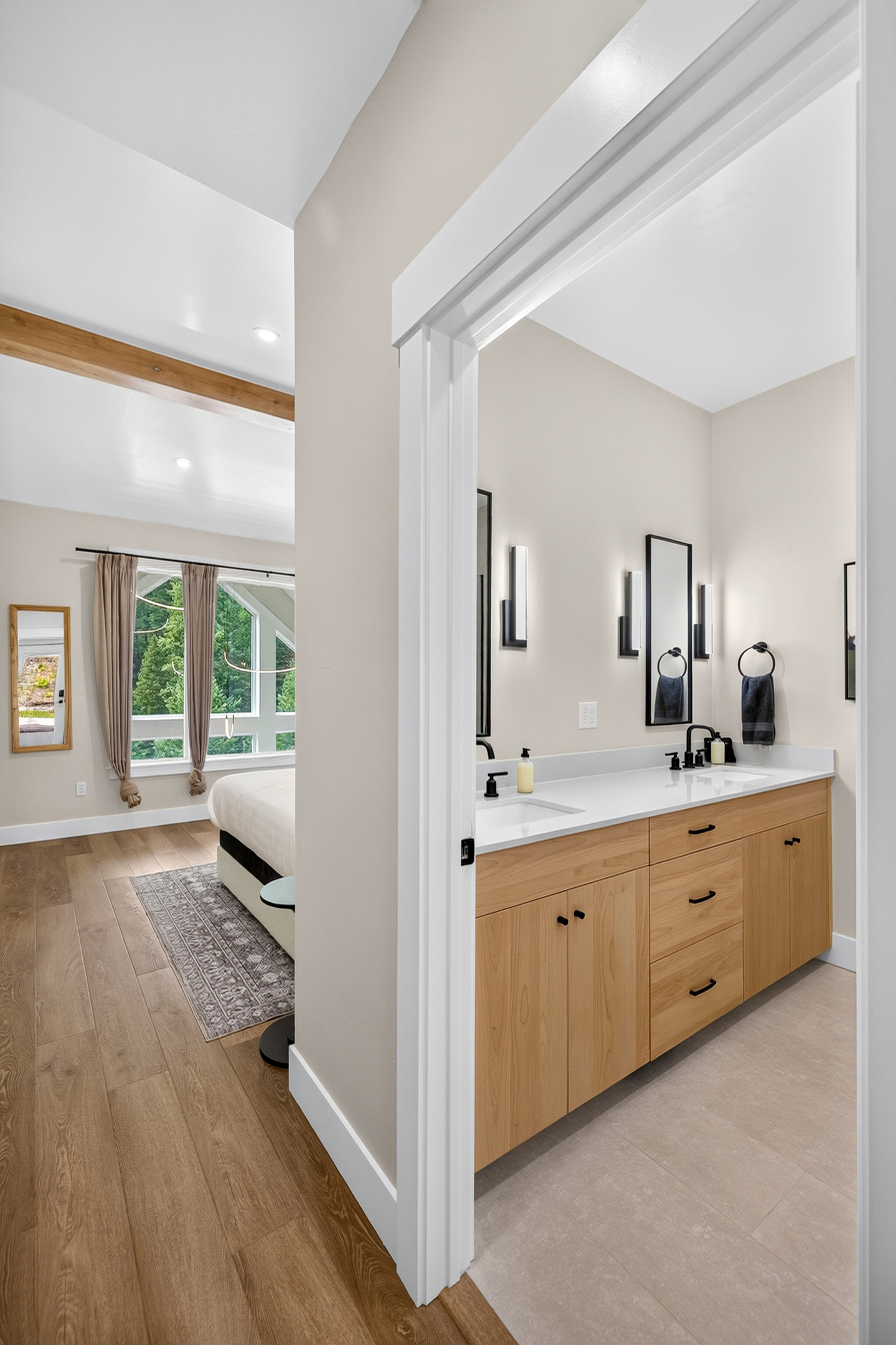 This bathroom is private to the primary bedroom and includes dual vanity, shower and toilet.