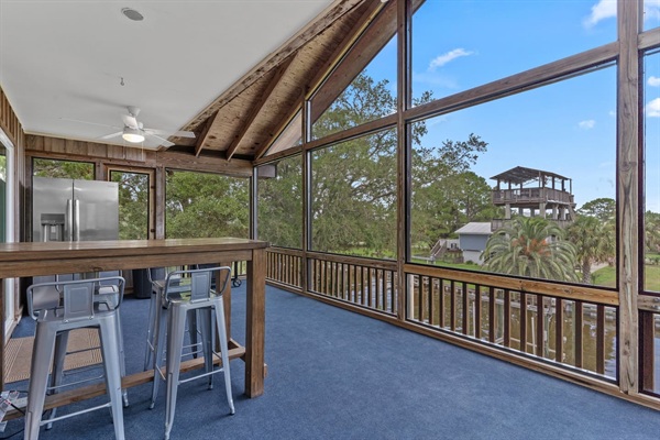Canal Screened Porch with outdoor seating, bait fridge, and drinks fridge