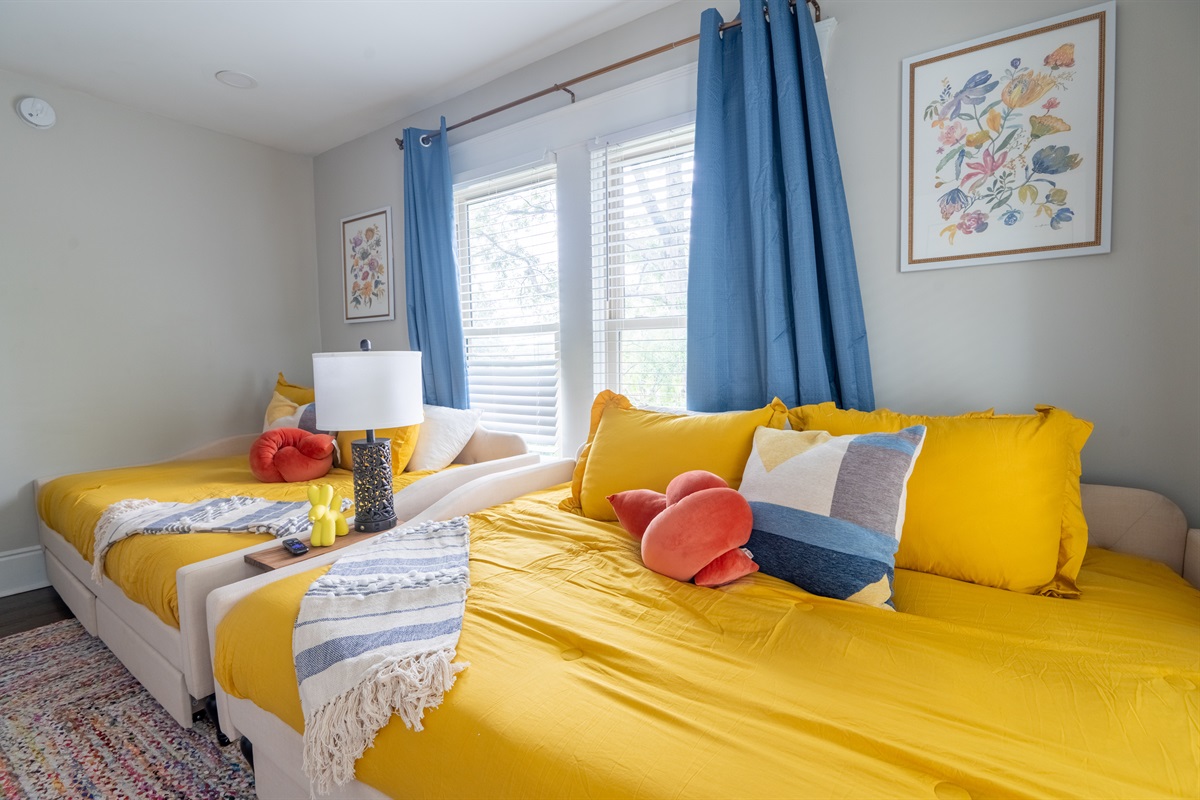 Restful Retreat: Our thoughtfully designed guest bedroom features two full-sized daybeds with convenient under-bed storage and a smart TV. Perfect for additional guests, this space combines pr