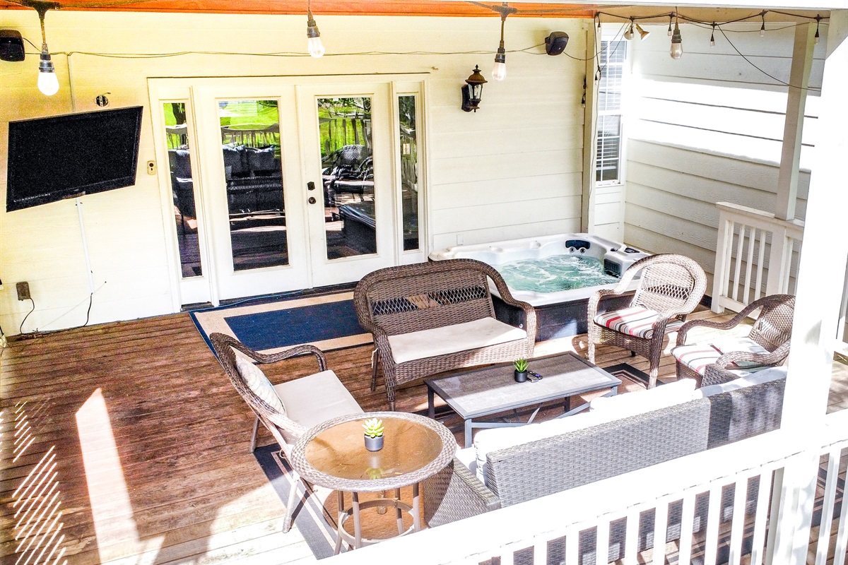 Covered deck with hot tub and TV