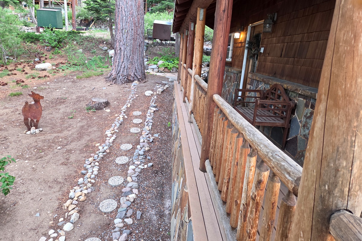 Our side deck and side yard area with rustic metal decor and stepping stones.  Out front doorway and entry to the house is covered to help protect from the elements.