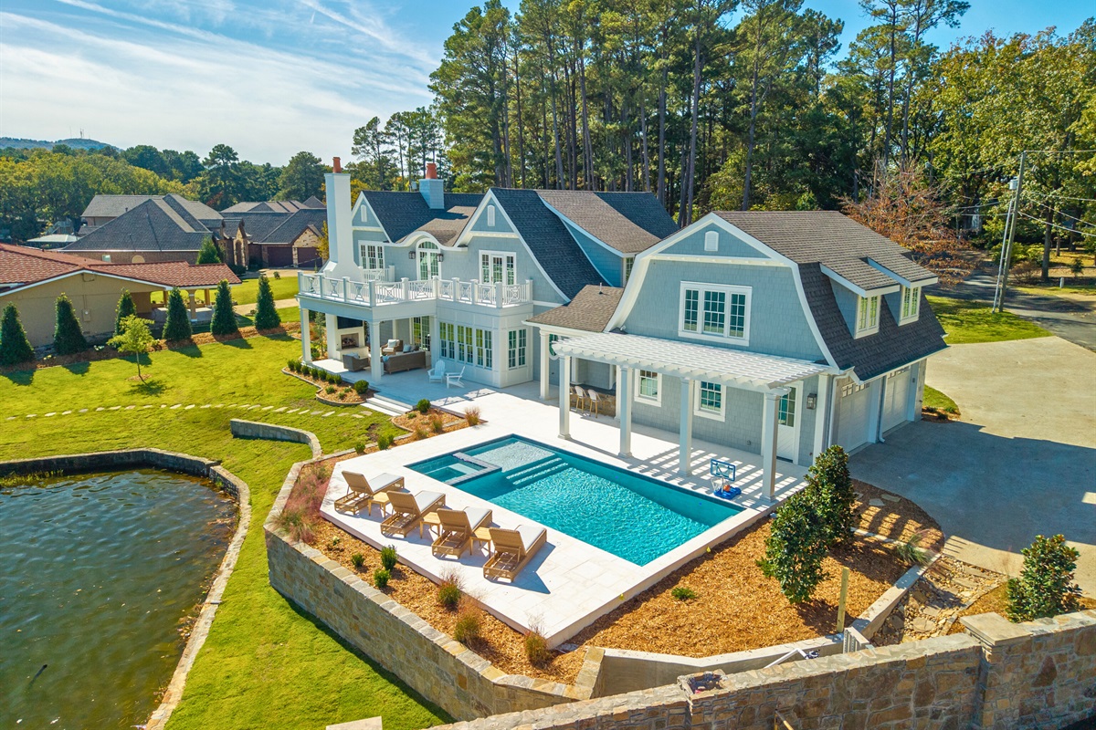 Expansive lakefront with outdoor living and private dock.