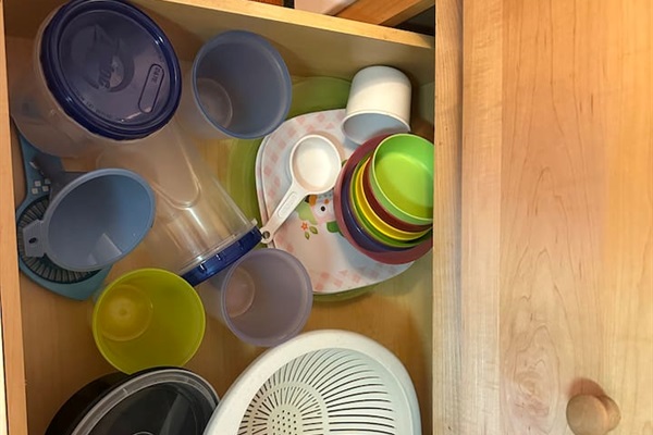 Fully stocked kitchen with everything you need—cookware, utensils, dishware, and coffee maker. Compact yet efficient, ready for cooking meals or enjoying takeout with ease.