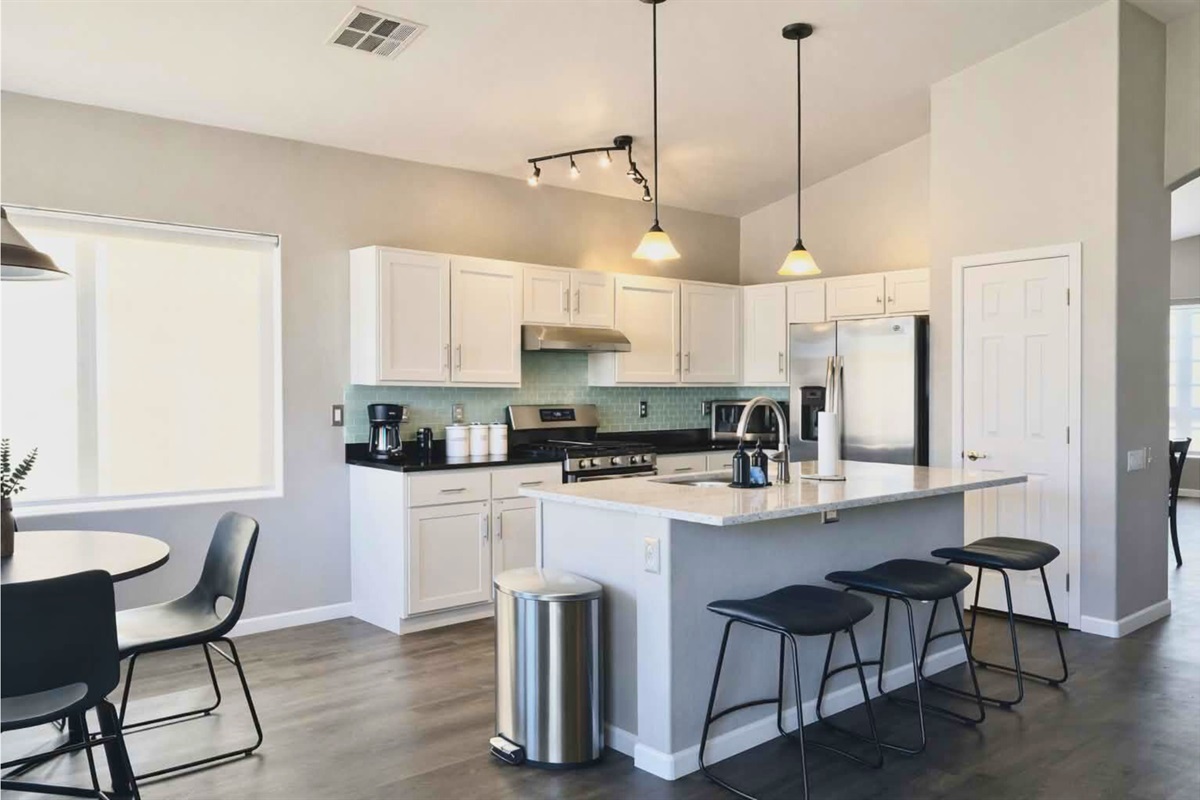 Bright, open kitchen with full amenities and modern lighting — ideal for family cooking and entertaining. 