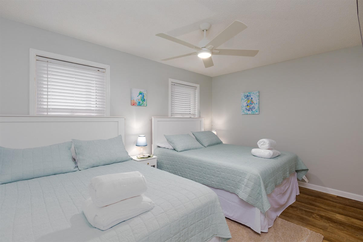 Cozy bedroom with fan, featuring essential indoor furniture