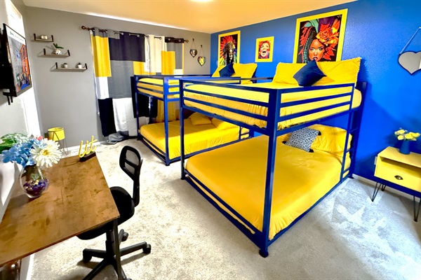Showcasing the other side of the bedroom, which includes two bunk beds and a large window that allows plenty of natural light to fill the space.