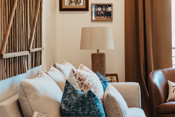 Curated modern Western details in the Cutter's Quarters living room &mdash; handcrafted pillows, designer lamps, and refined finishes throughout.