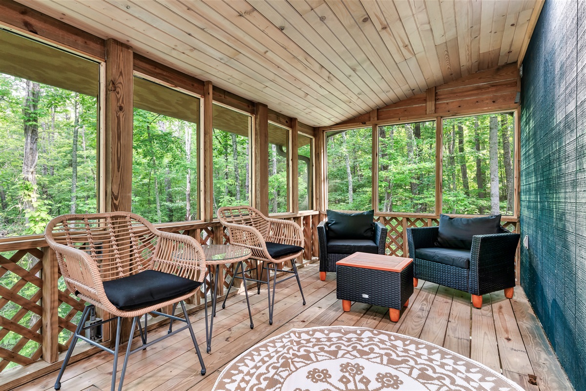 Your year-round mountain retreat! This spacious screened porch is the perfect spot to relax and enjoy the sights and sounds of the forest, rain or shine.