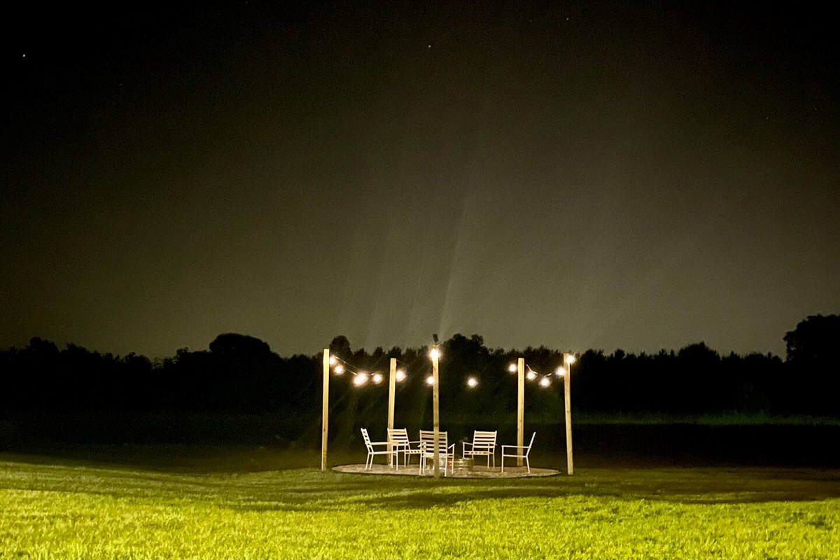 Fire pit lit under the night sky