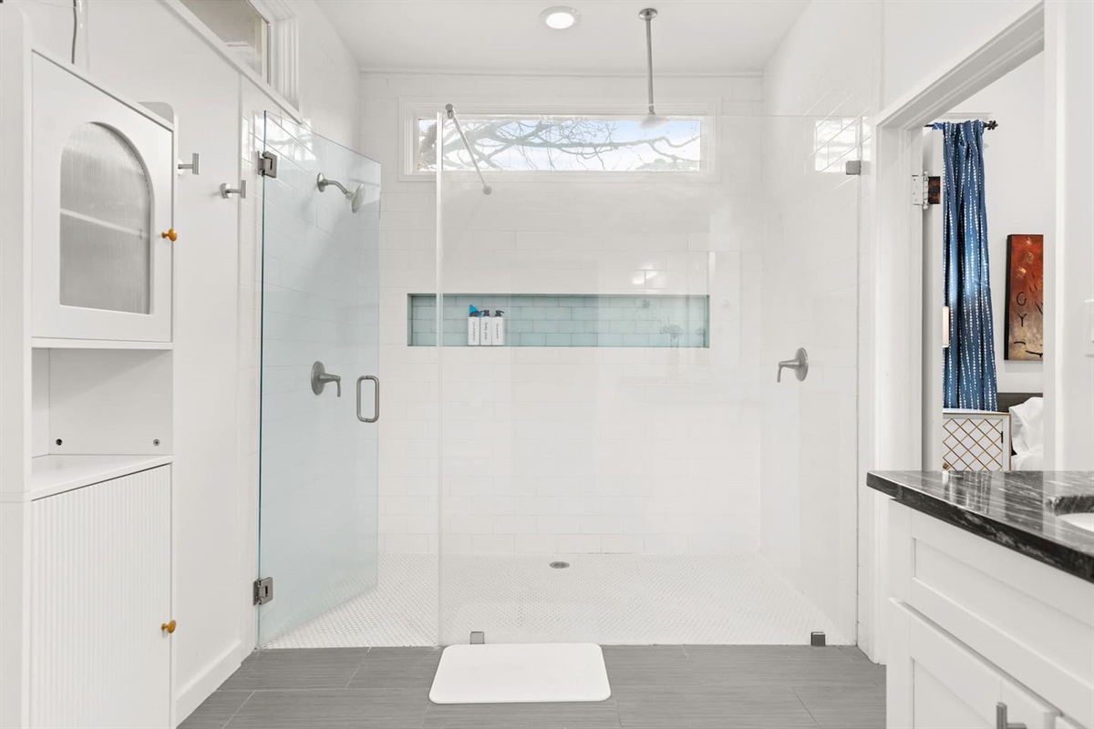 Refresh and rejuvenate in our serene bathroom, complete with a spacious walk-in shower with two shower heads to start your day with tranquility.
