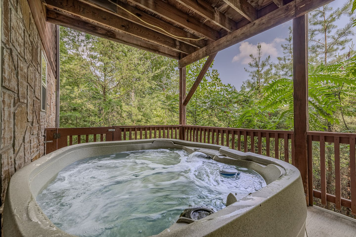 Relax in the private hot tub surrounded by wooded views.