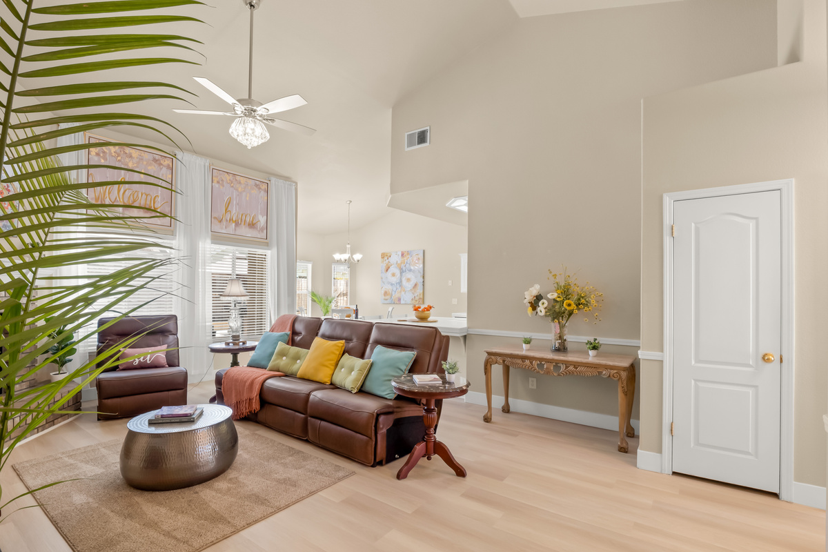 The heart of the home features an open and inviting living space with vaulted ceilings, comfortable reclining seating, and plenty of room to gather.