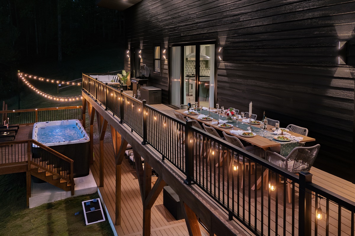 {String-Lit Dining Deck}
As the sun goes down, the deck comes alive with warm string lights, outdoor dining, and unforgettable mountain evenings. Picture dinner under the stars with room for the whole group.