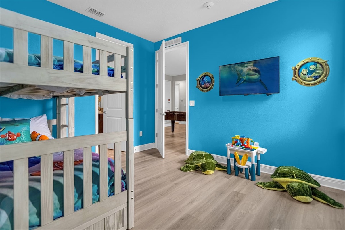 Colorful Finding Nemo-themed room with full-over-full bunk beds and twin trundles, accommodating up to five guests, designed with playful decor that captures the essence of the beloved underwater adventure.