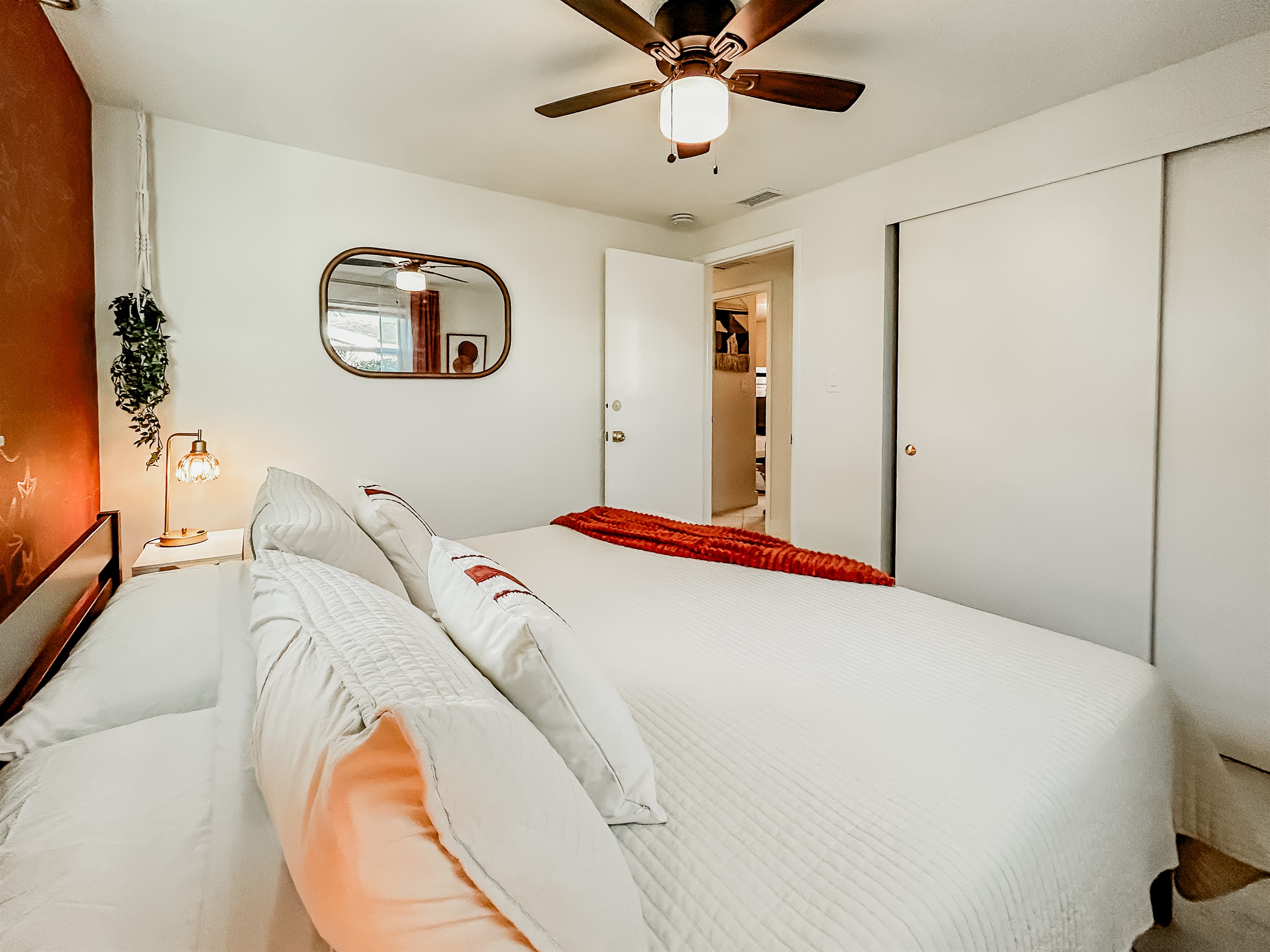 Master Bedroom with King Size Bed, Night Stands, Lamps/charging ports, Local Artist Mural, 4 King Sized Pillows, Mirror, Table Top Fan for White Noise, Iron, Ironing Board, Luggage Rack & More