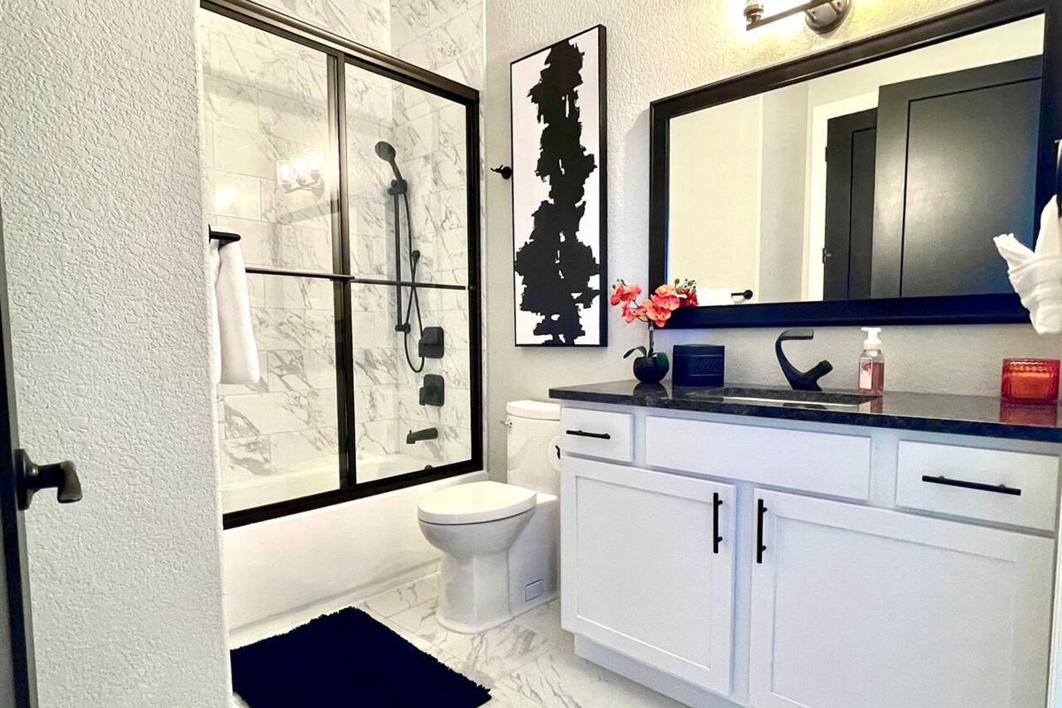 Second King bedroom’s luxury bathroom and hallway entrance bathroom. Tub, shower, sink, and toilet. 