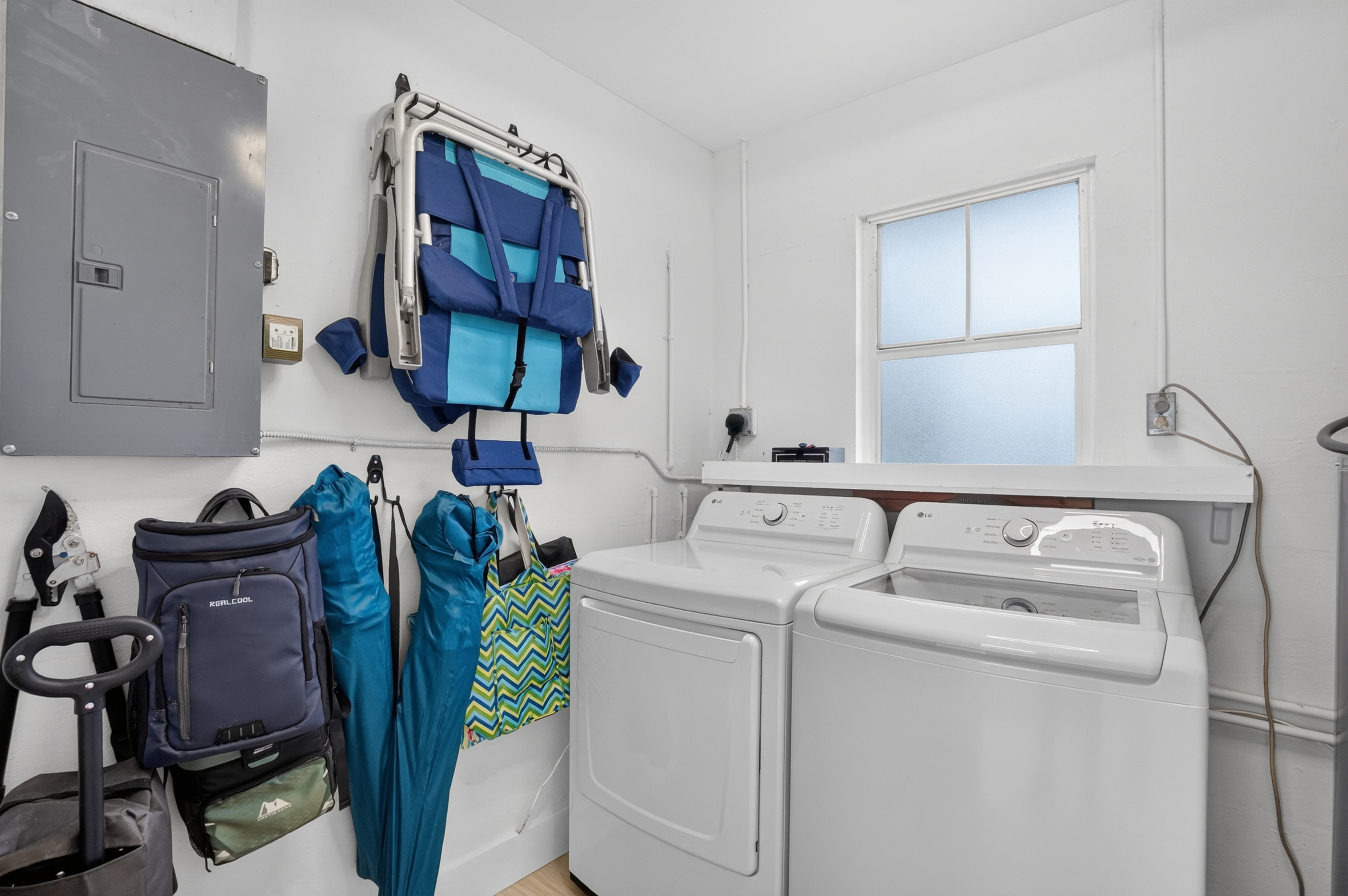 The private laundry room includes a full-size washer and dryer along with conveniently stored beach gear.
