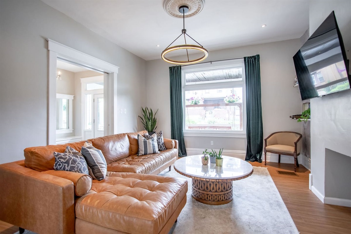 Cozy living area with a comfortable couch, perfect for relaxing, reading, or enjoying your favorite shows in a laid-back setting.