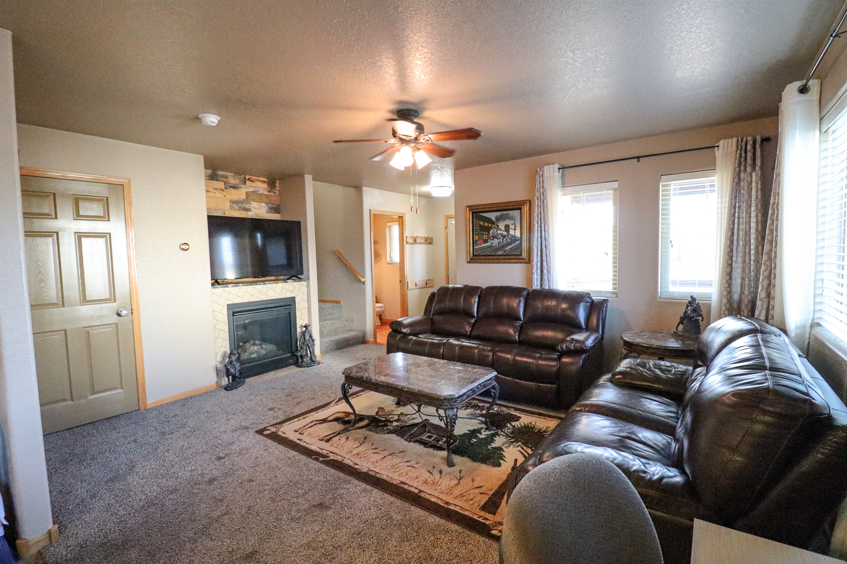 Living room with gas fireplace and half bath off the main living space