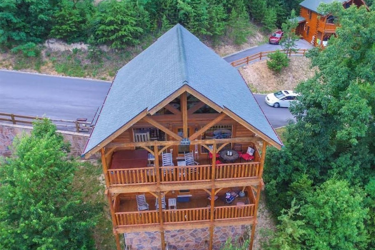 - Aerial view revealing spacious decks perfect for outdoor relaxation   - Overlooking scenic forest roads and mountain views in every direction   - Ideal cabin layout designed for both privacy and panoramic enjoyment