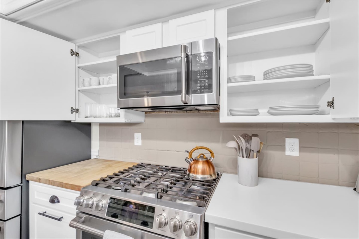 Sleek and functional updated kitchen with stainless steel appliances and style to spare.