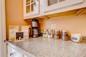 kitchen countertop with coffee maker and different types of coffee