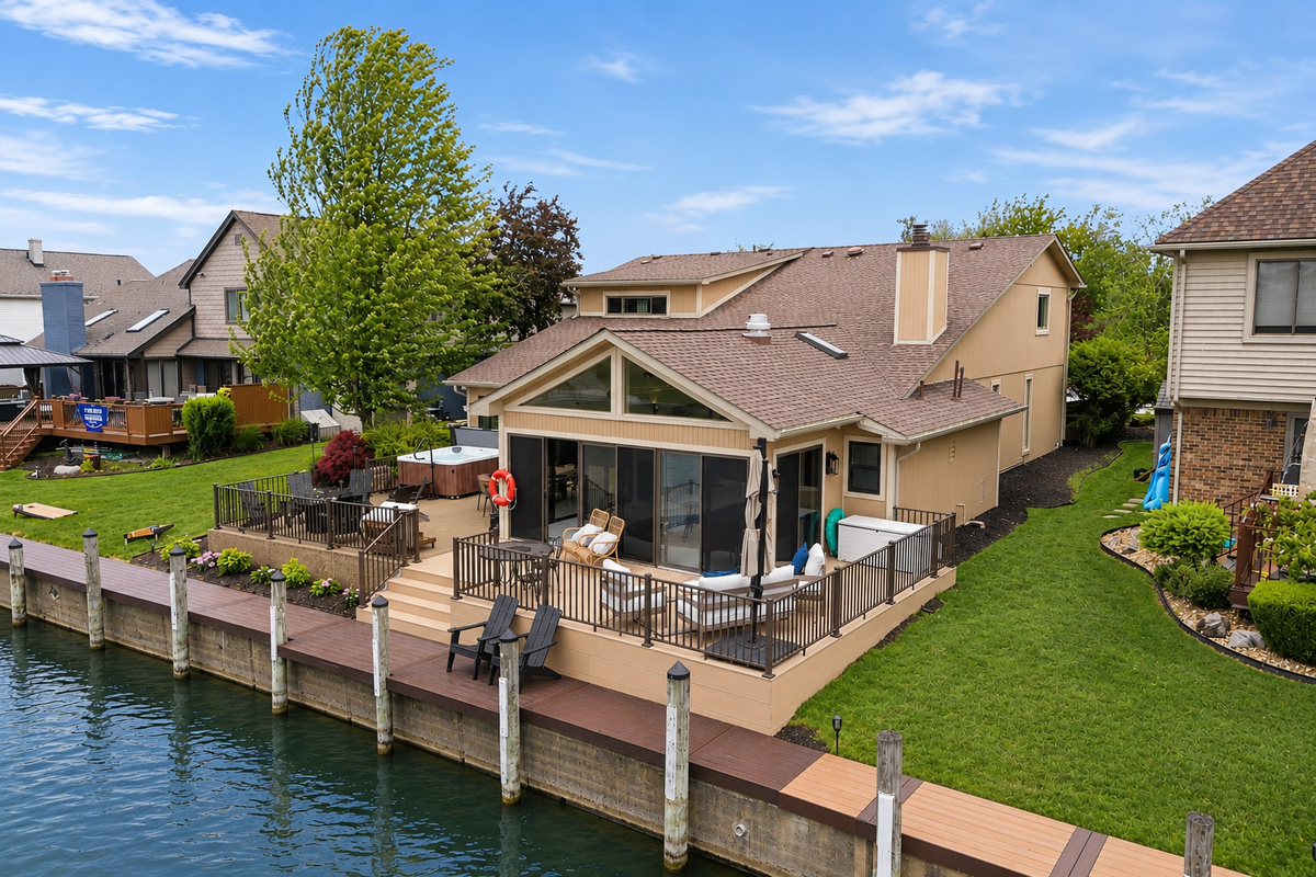 Waterfront luxury retreat with private dock, spacious deck, and relaxing outdoor seating with Hot tub for a perfect getaway.