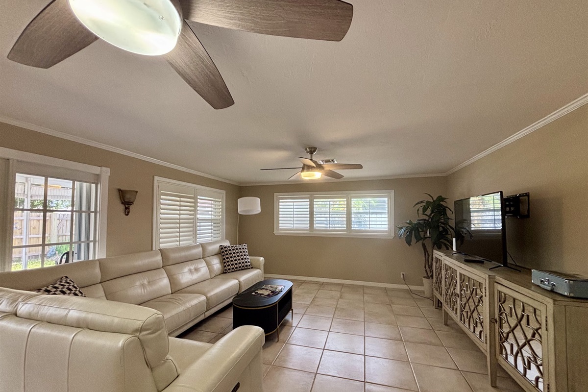 Our expansive rear living room has an abundance of seating and cozy nooks, as well as a comfortable couch with recliners.