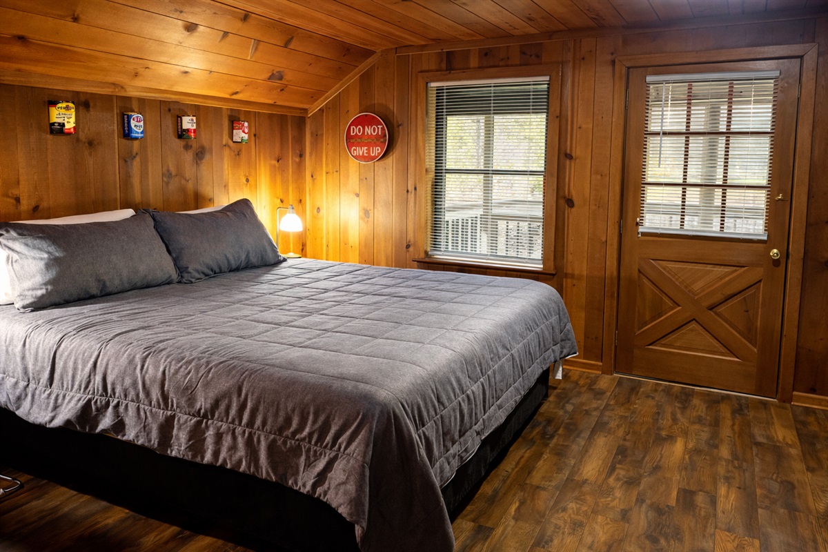 End the day with a peaceful night’s sleep in this inviting mountain cabin bedroom.